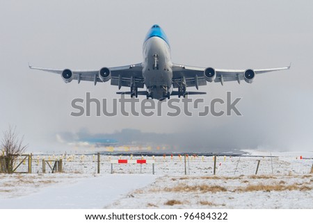 Aircraft taking off in snowy conditions