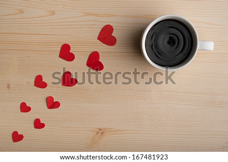 path of red hearts on the table, leads to a hot cup of coffee