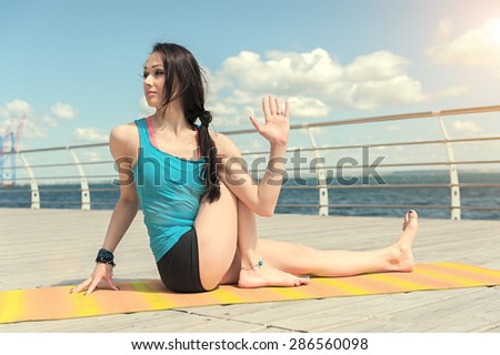 Yoga on the background of the sea. Pose curling