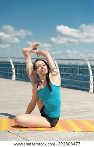 Yoga on the background of the sea. Pose curling