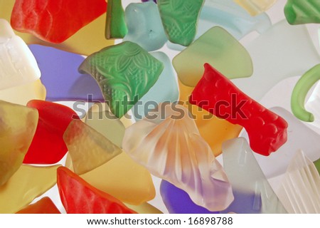 Full frame photo of colorful, broken textured glass pieces that have been tumbled to make them resemble sea glass.