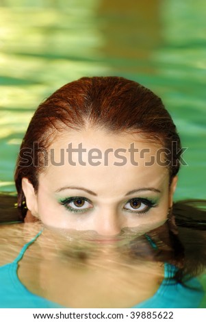 young woman face part under water
