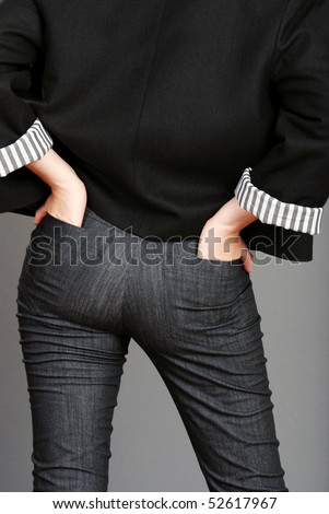 woman with hands in back jeans pockets