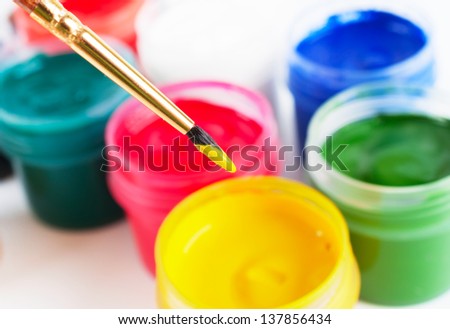 Brush and many paint jars with gouache