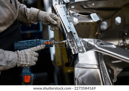 Similar – Image, Stock Photo Crop worker assembling mechanism in workshop
