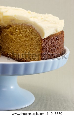 A freshly baked caramel cake with creamed butter icing.