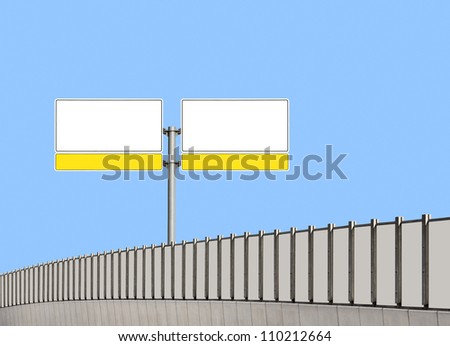 Blank traffic sign and noise barrier fence on the highway