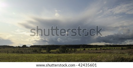 Rural landscape and cloudscape. Autumn evening. In expectation of a thunder-storm