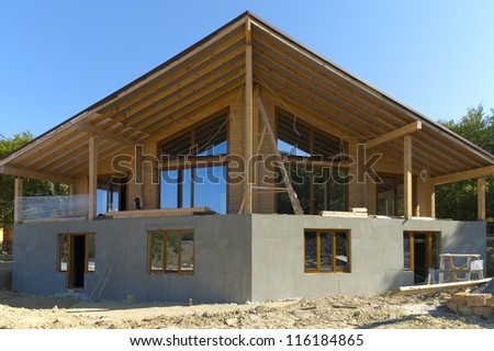 Construction of a large beautiful two-story wooden house.