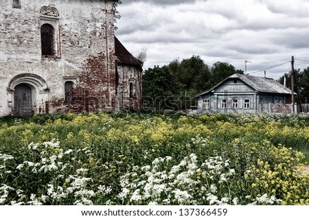 Monastery in Suzdal, Russia with dandelion field and old House