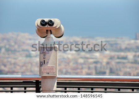 Touristic telescope with view of Barcelona, Spain from mountain