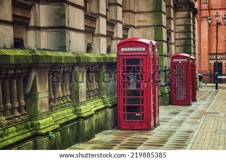 Two red british telephone booths in the historical center of the Birmingham, UK