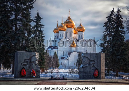The Uspensky Cathedral in Yaroslavl, Russia in Winter - Golden domes and Crosses covered with snow. Famous touristic place at \