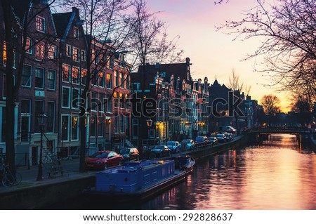 Sunset over Amsterdam, Netherlands canals and bridges. Night view of Keizersgracht and famous touristic place