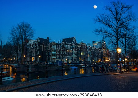 Full moon over Amsterdam, Netherlands canals and bridges. Night view of Keizersgracht and famous touristic place