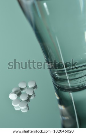 pills and drink water on mirror reflection