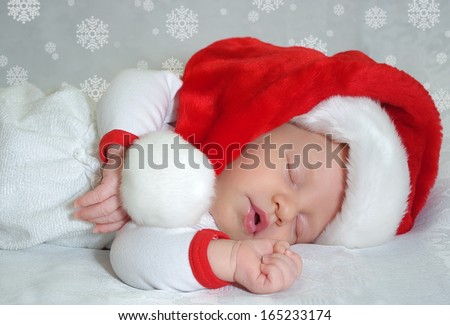 Sleeping christmas newborn baby in  Santa Claus red hat. Photo for calendar, card