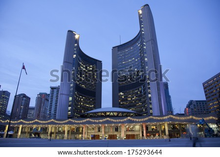TORONTO, CANADA - JANUARY 17, 2014: Toronto\'s City Hall on Nathan Phillips Square at night - home of municipal government of Toronto, Ontario. It was designed by architect Viljo Revell.