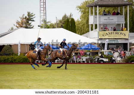 TORONTO - JUNE 22, 2014: Polo match between two teams at the Polo For Heart fundraiser in Toronto. Polo For Heart has raised more than $5 million for heart and stroke related charities.