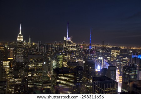Manhattan Skyline and Empire State Building, viewed from Rockefeller Plaza at night, New York City.