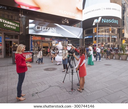 NEW YORK - May 29, 2015: News reporter and crew in Times Square, New York City on May 29,2015.