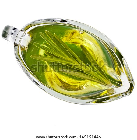 Olive oil sauce with rosemary herbs in the  in gravy boat  top view isolated on white background