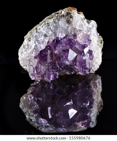 Single Natural cluster of Amethyst, violet variety of quartz close up macro with reflection  on black background