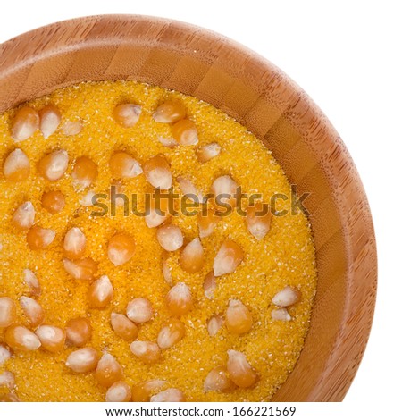 cornmeal maize flour surface in wooden bowl dish isolated on white background