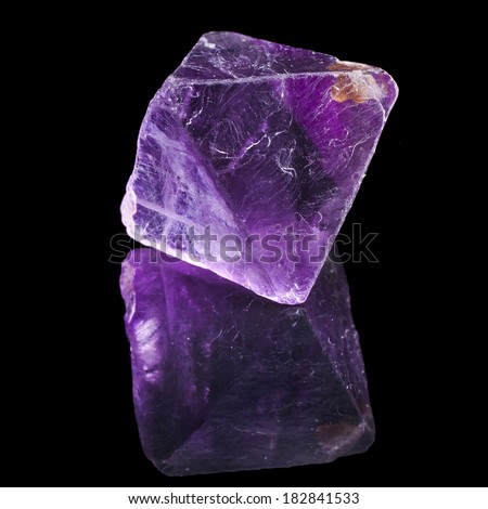 Purple Violet Fluorite with reflection on black surface background