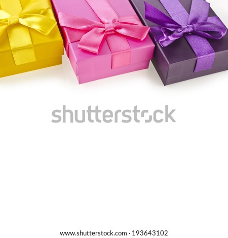 Border rows of colorful gift boxes with bows isolated on a white background