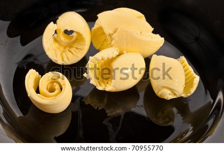 butter curl in the black dish background