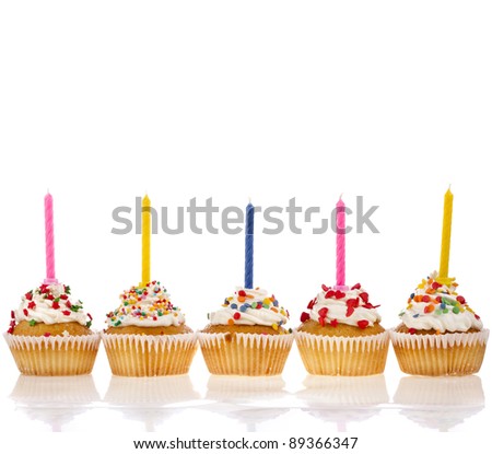 birthday cupcakes with colorful  sweet sprinkles and  candle on white  background