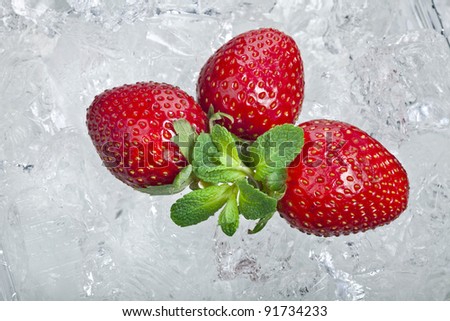 Sweet strawberries in the  ice cubes with  mint leaf on white background
