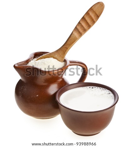 powder milk drink  in  clay  pitcher and cup on white background