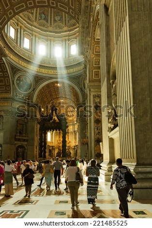 VATICAN CITY, VATICAN - JULY 15 2014: People at the interior of the Saint Peter Cathedral in Vatican. Saint Peter\'s Basilica has the largest interior of any Christian church in the world.