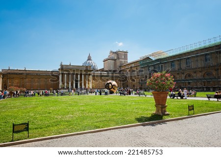 VATICAN CITY, VATICAN - JULY 15 2014: People around Sphere within sphere in Courtyard of the Pinecone at Vatican Museums. Sphere was created in 1990 by Italian sculptor Arnoldo Pomodoro.