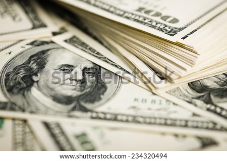 Stack of one hundred dollar bills close-up. (shallow DOF)