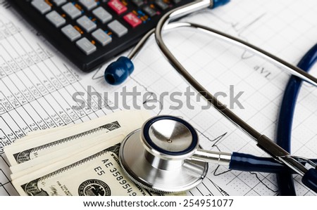 Stethoscope and calculator symbol for health care costs or medical insurance