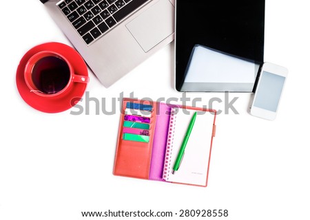 Office desk with laptop computer, tablet pc, planner, pen, mobile smartphone and cup of tea on white background