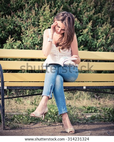 Woman read a magazine in park