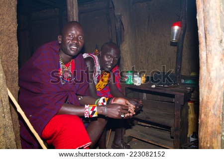 ARUSHA, TANZANIA - AUGUST 10: Masai men insite a typical house in their camp, masai people still live in the old way with traditional dress august 10, 2014 in Arusha, Tanzania