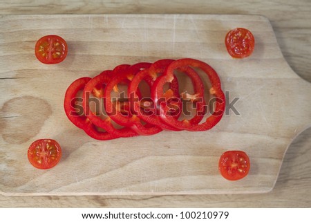 stock-photo-group-of-fresh-red-peppers-and-little-tomatoes-on-a-wooden-desk-100210979.jpg