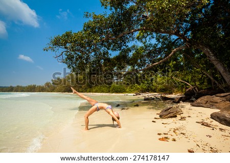 Summer yoga session on a beach - tropical Koh Rong island, Cambodia. Chakra-asana, wheel pose