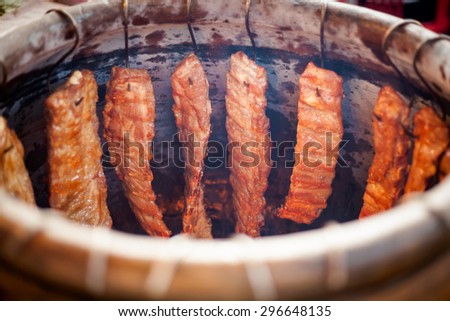 Traditional thai clay oven full of meat. Traditional baked rack of ribs thai cuisine.