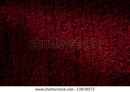 Light casting shadow over dark red textured background