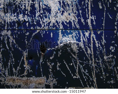 Dark blue metal background with bullet hole and scratch marks