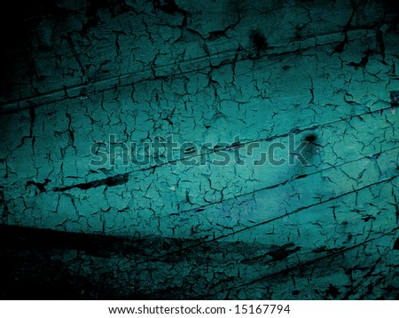 Dark shadow around turquiose blue cracked wooden background showing the hull of a old boat