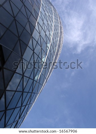 Swiss Re building also know as the Gherkin with bright blue sky City of London, England UK