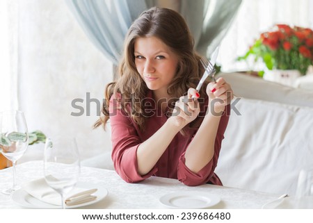 Hungry woman is waiting an order in a restaurant