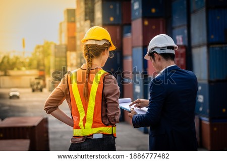 Container Depot chief talking to female foreman about custom document of the goods inside Empty Container depot in Broad daylight ストックフォト © 